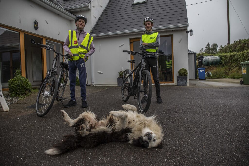 Conor O’Callaghan and his younger brother, Cormac, with their electric bicycles and a dog at their home.