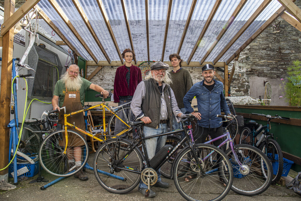 Jack Kelleher of Clonakilty, West Cork in an outdoor area with other people and his electric bicycle.