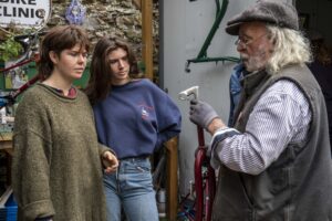 Jack Kelleher of Clonakilty, West Cork examining a bicyce part with other people.