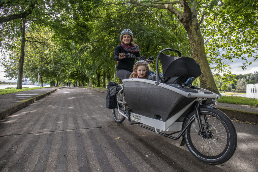 Orla Burke of Cork with her children cycling an electric cargo bicycle at the Marina in Cork.