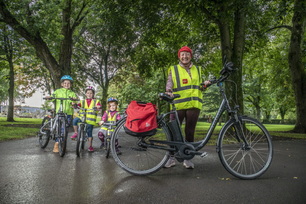 Siún Kearney of Cork with her grandchildren and her electric bicycle.