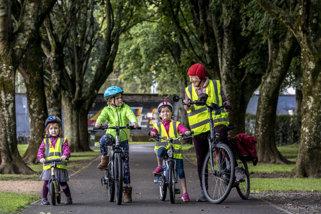 Siún Kearney of Cork with her grandchildren and her electric bicycle.