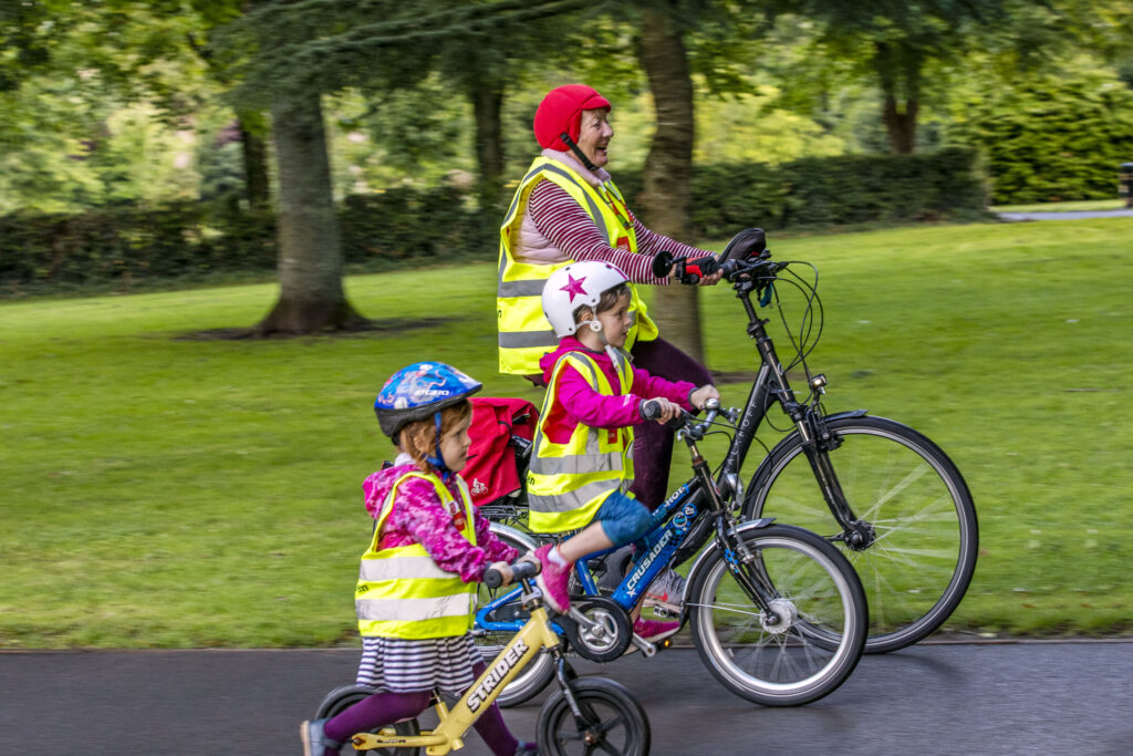 Siún Kearney of Cork cycling her electric bicyle with her grandchildren in Fitzgeral's Park.