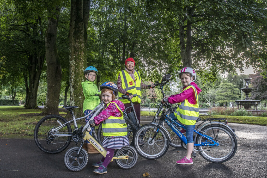 Siún Kearney of Cork with her grandchildren and her electric bicycle.