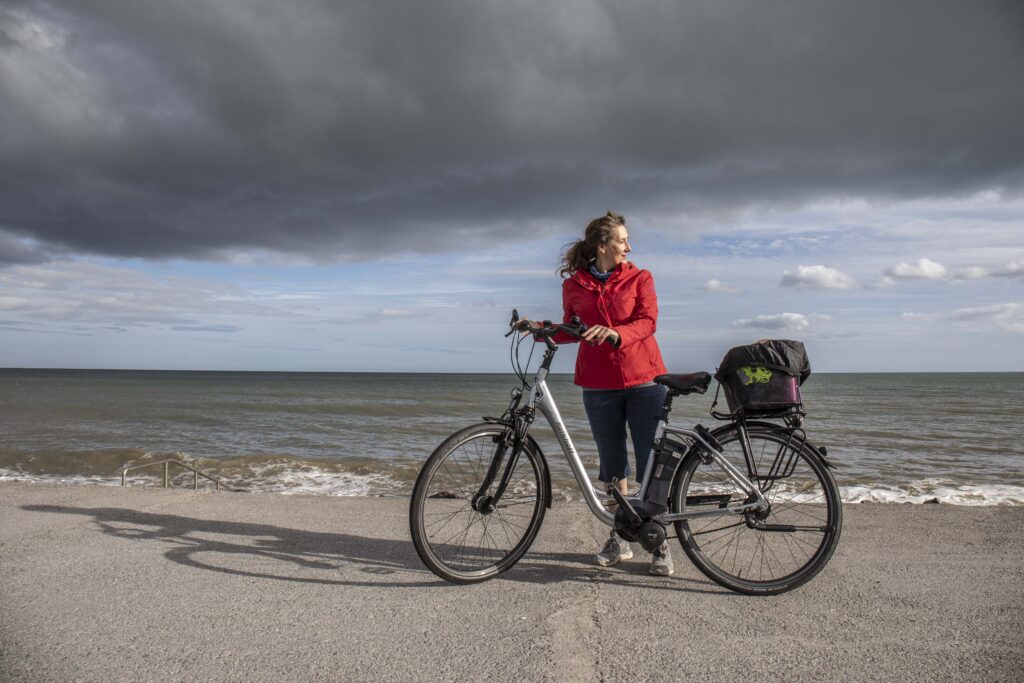 Teresa Watkins of Youghal, Co. Cork standing with her electric bicycle at the sea front in Youghal.
