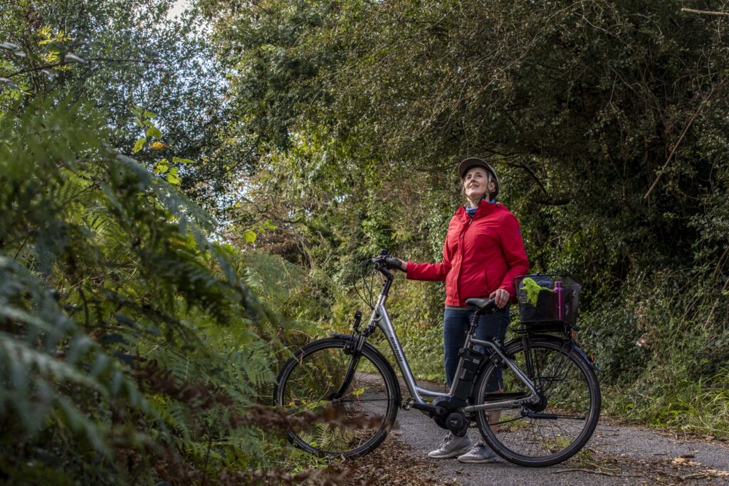 Teresa Watkins of Youghal, Co. Cork wihth her electric bicycle on a country road.