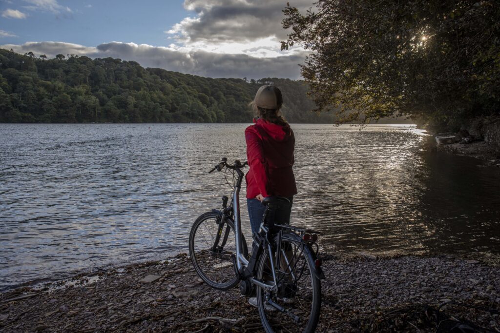 Teresa Watkins of Youghal, Co. Cork with her electric bicycle near a waterfront.