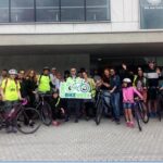 People outside Cork City Council offices holding a Bike Week banner.