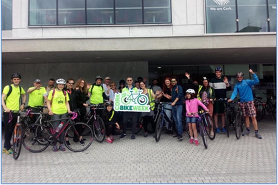 People outside Cork City Council offices holding a Bike Week banner.